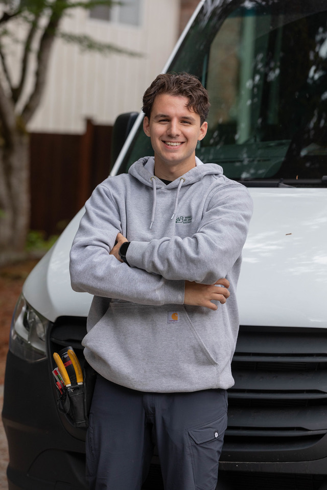 A Wired by Dave electrician beside the service van